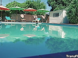 skinny brunette ladyboy in black dress jerks off on the bed